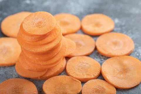 Stack of carrot slices on grey background Foto stock