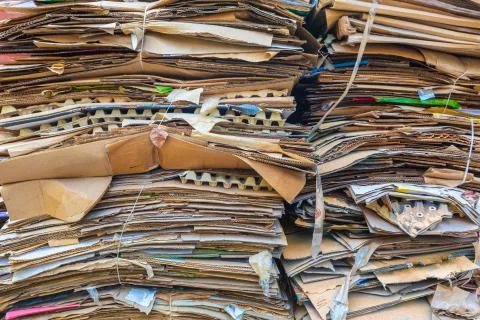 Stack of cartons and paper waiting to be picked up by the garbage trucks Stock Photos