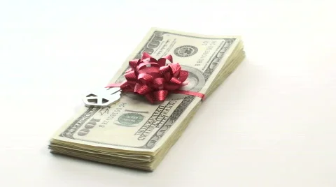 Stack of cash with bow and key zoom - HD Stock Footage 571676