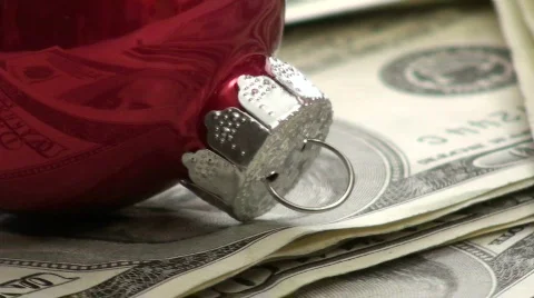 Stack of cash with Christmas baubles macro - HD Stock Footage 571853