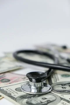 Stack of cash dollars and stethoscope. The concept of medical expensive medic Stock Photos