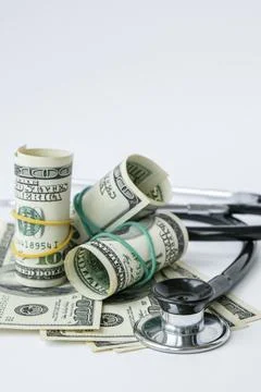 Stack of cash dollars and stethoscope. The concept of medical expensive medic Stock Photos