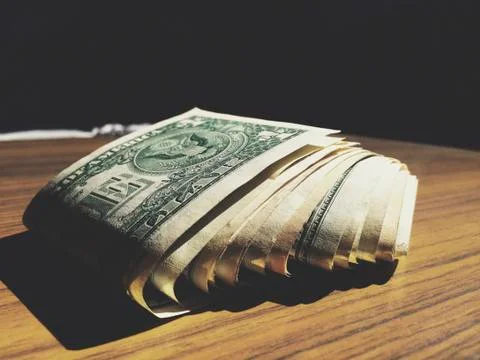 Stack of cash on a table. Stock Photos