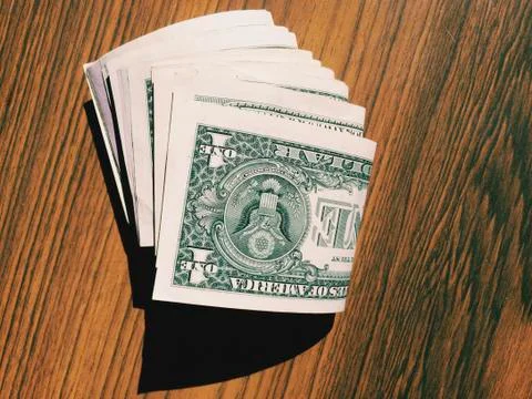 Stack of cash on a table. Stock Photos