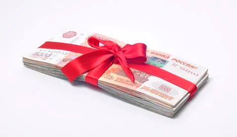 Stack of cash tied with red gift ribbon Stockfoto's