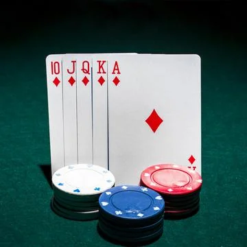 Stack casino chips front royal flush playing card poker table Photos