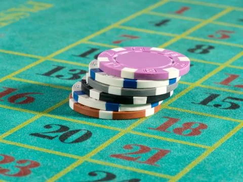 Stack of casino chips on a numbered board Stock Photos