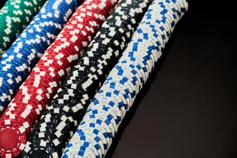 Stack of Casino gambling chips isolated on black reflective background Stock Photos