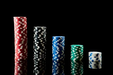 Stack of Casino gambling chips isolated on black reflective background Photos