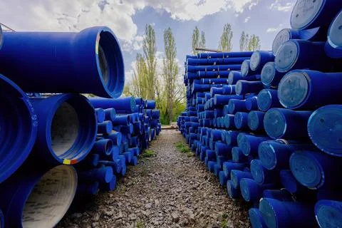 Stack of cast iron pipes in loading area waiting for transportation Stock Photos