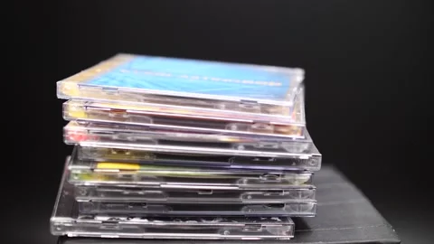 Stack of CDs being dropped in slow motion music the '90s Video stock 206283242