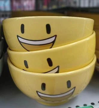 Stack of ceramic bowls with smiling images Stock Photos