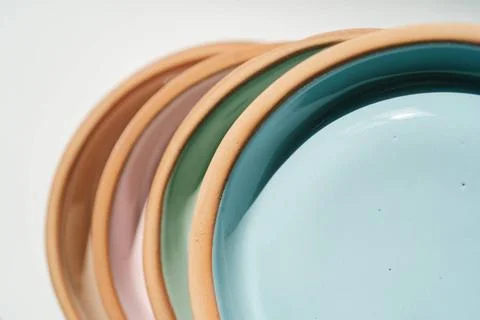 A stack of ceramic cups in pastel colors. A stack of ceramic cups, plates ... Stock Photos