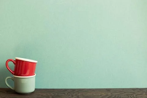 Stack of ceramic mug cups on wooden table. green background Stack of ceram... Stock Photos