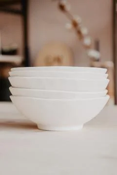 Stack of ceramic plates on cozy back Stock Photos