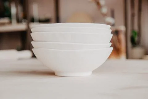 Stack of ceramic plates on cozy back Stock Photos