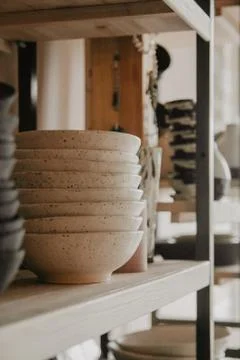 Stack of ceramic plates on cozy back Stock Photos