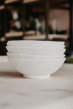 Stack of ceramic plates on cozy back Stock Photos
