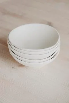 Stack of ceramic plates on cozy back Stock Photos
