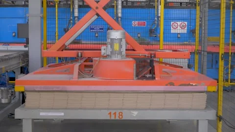 Stack of ceramic tiles neatly arranged on automated platform in tile factory Stockbeeldmateriaal 307240361