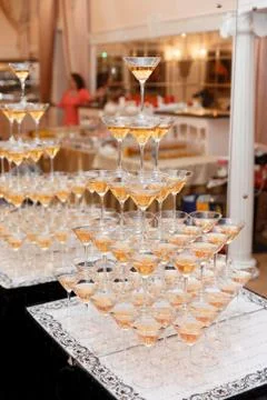 Stack of champagne glasses on table in wedding party. Stockfoto's