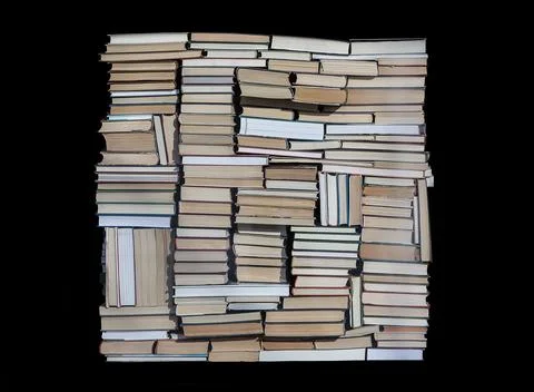 Stack of chaotically stacked books of different size and form. Isolated. Stock Photos