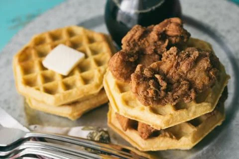 Stack of chicken and waffles on a silver tray. Fotos de archivo