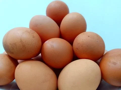 Stack of chicken eggs in a basket. Stock Photos