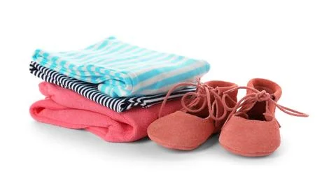 Stack of child clothes and cute shoes isolated on white 스톡 사진