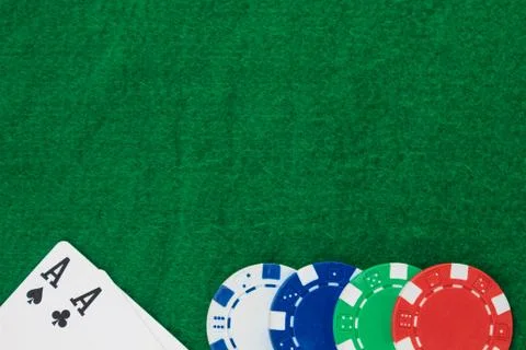Stack of chips poker and two aces on the table on the green baize. Copy space Stock Photos