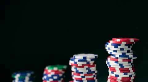 Stack chips poker on a table background Stock Photos