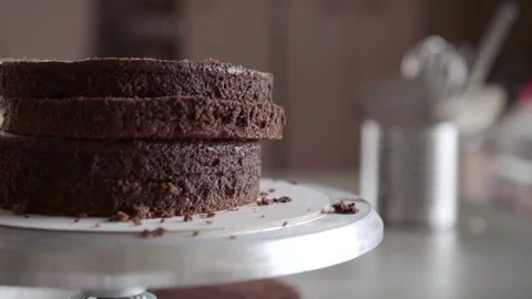 Stack of chocolate biscuits shells prepared for assembly of tiered cake Stock Footage 131089306