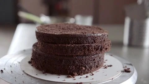 Stack of chocolate biscuits shells prepared for assembly of tiered cake Stock Footage 131089465
