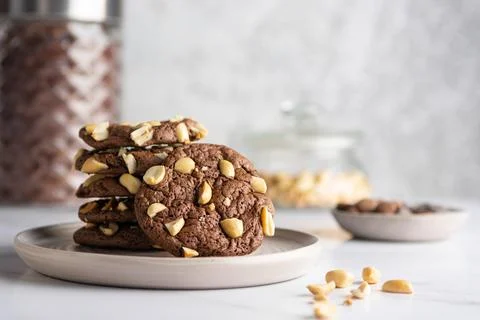 Stack of chocolate brownie cookies with peanuts on a ceramic plate with nuts Stock Photos
