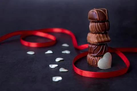 Stack of Chocolate candy and red ribbon Фото