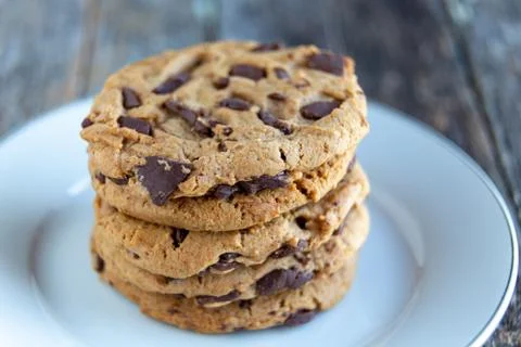Stack of chocolate chip chunk cookies on white plate. Stock Photos
