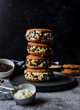 Stack of chocolate chip cookie ice cream sandwiches on a plate. Stock Photos