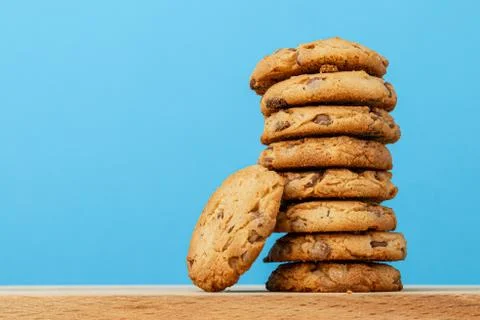 Stack of chocolate chip cookies against blue background Stock Photos