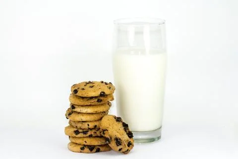 A stack of chocolate chip cookies and glass of milk on a white background. Stock Photos