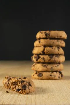 A stack of chocolate chip cookies with half a cookie in the foreground 写真素材