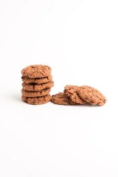 Stack of chocolate chip cookies with loose ones leaning beside it isolated .. Stock Photos