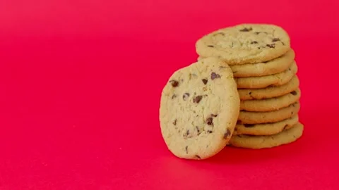 A stack of chocolate chip cookies on a red background Stock Footage 310251628