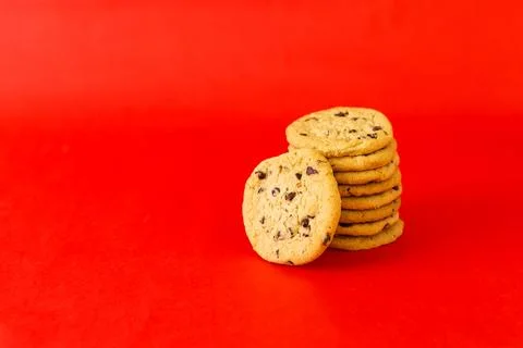 A stack of chocolate chip cookies on a red background Stock Photos