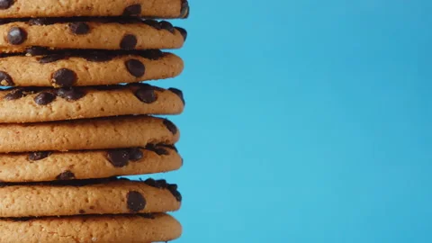 A stack chocolate chip cookies rotate on a blue background. American cookies Stock Footage 156803528