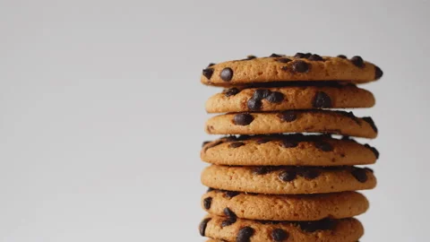 A stack of chocolate chip cookies rotate on a light background. Stock Footage 157476848