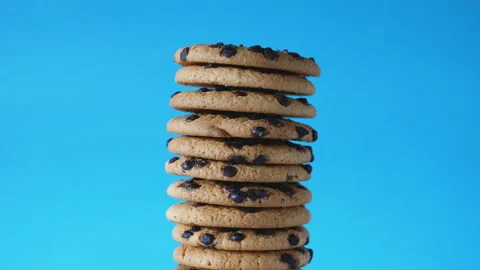 A stack chocolate chip cookies rotate on a blue background. American cookies Stock Footage 170187094