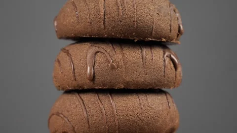 A stack of chocolate chip cookies rotates on a gray background.close-up Stock Footage 241926336