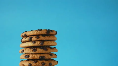 A stack of chocolate chip cookies sprout on a blue background. American cookies Stock Footage 156797834