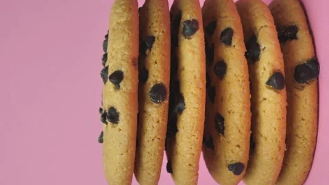 A stack of chocolate chip cookies sprouting on a pink background. Stock Footage 195102506
