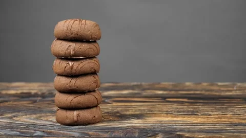 A stack of chocolate chip cookies sprouts on a gray background, a wooden table Stock Footage 241916656